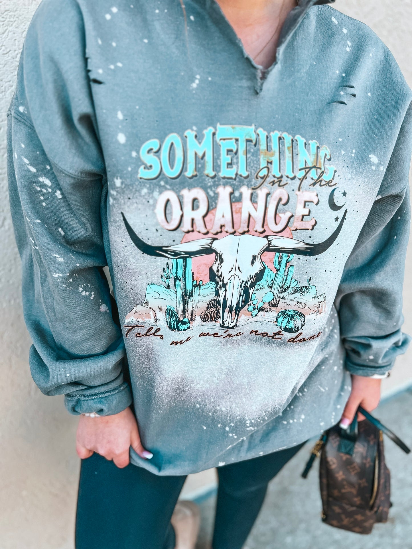 SOMETHING IN THE ORANGE SWEATSHIRT